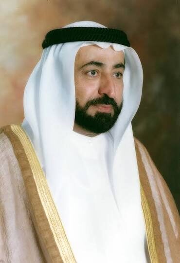 Formal portrait of Sultan Muhammad Al Qasimi wearing a gold-trimmed bisht