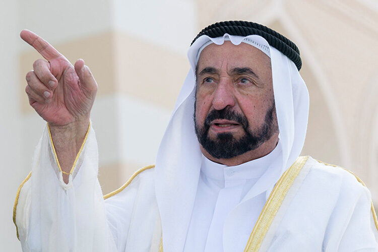 Sultan Muhammad Al Qasimi raising a hand to make a point during a public appearance